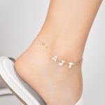 Personalized Opal monogram pearl anklet featuring mother of pearl letters and a delicate heart gold chain, perfect for adding a touch of elegance to bridal, beach, or everyday outfits.