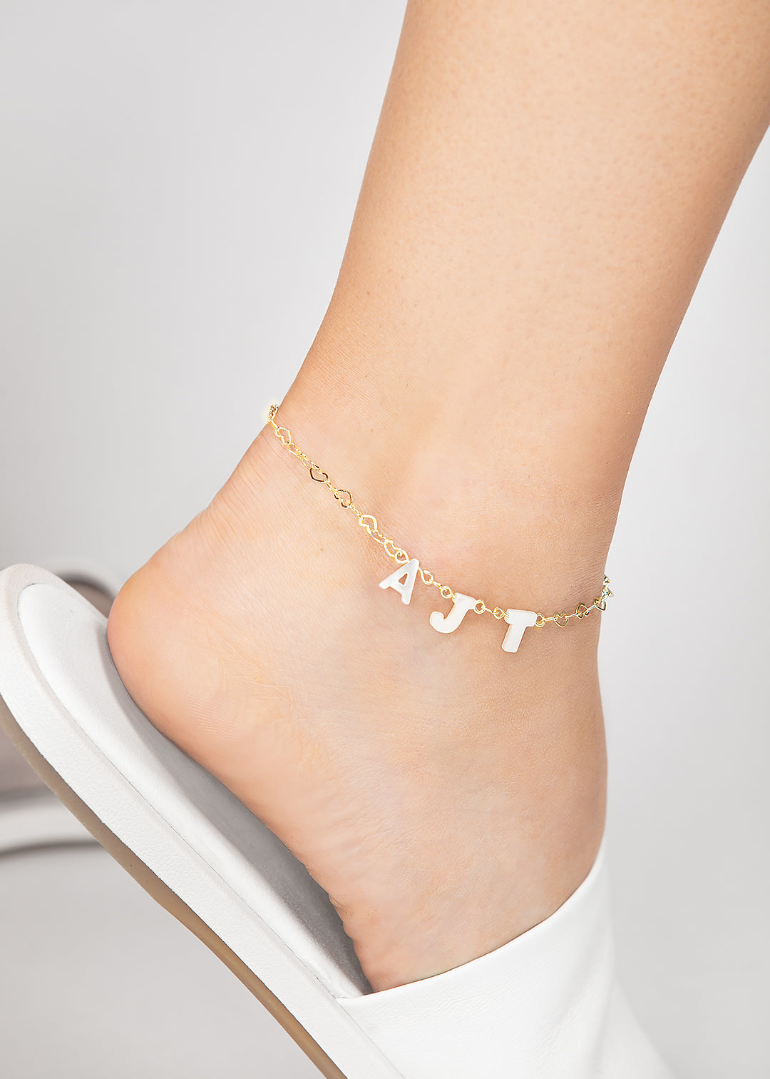 Personalized Opal monogram pearl anklet featuring mother of pearl letters and a delicate heart gold chain, perfect for adding a touch of elegance to bridal, beach, or everyday outfits.