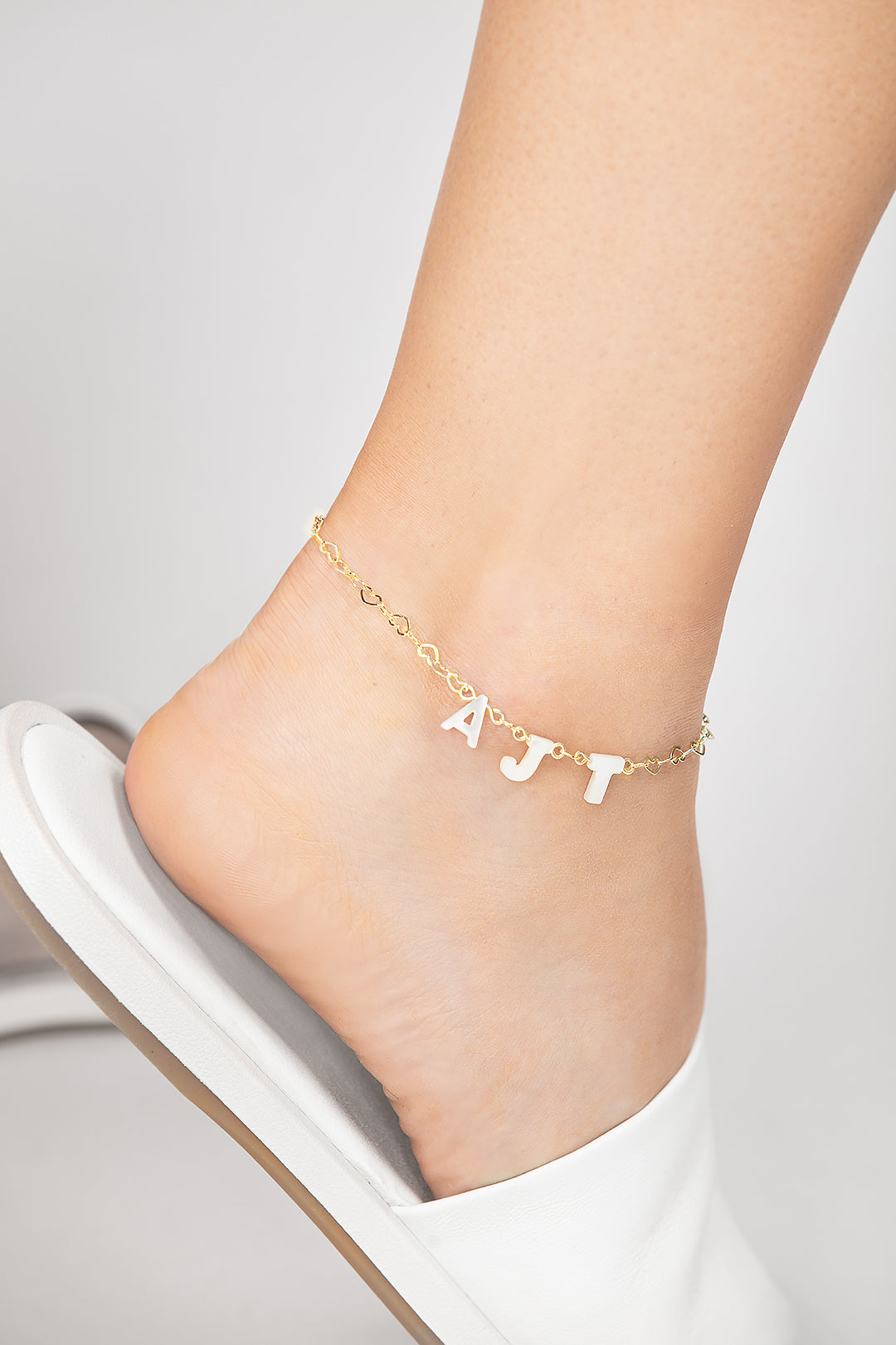 Personalized Opal monogram pearl anklet featuring mother of pearl letters and a delicate heart gold chain, perfect for adding a touch of elegance to bridal, beach, or everyday outfits.