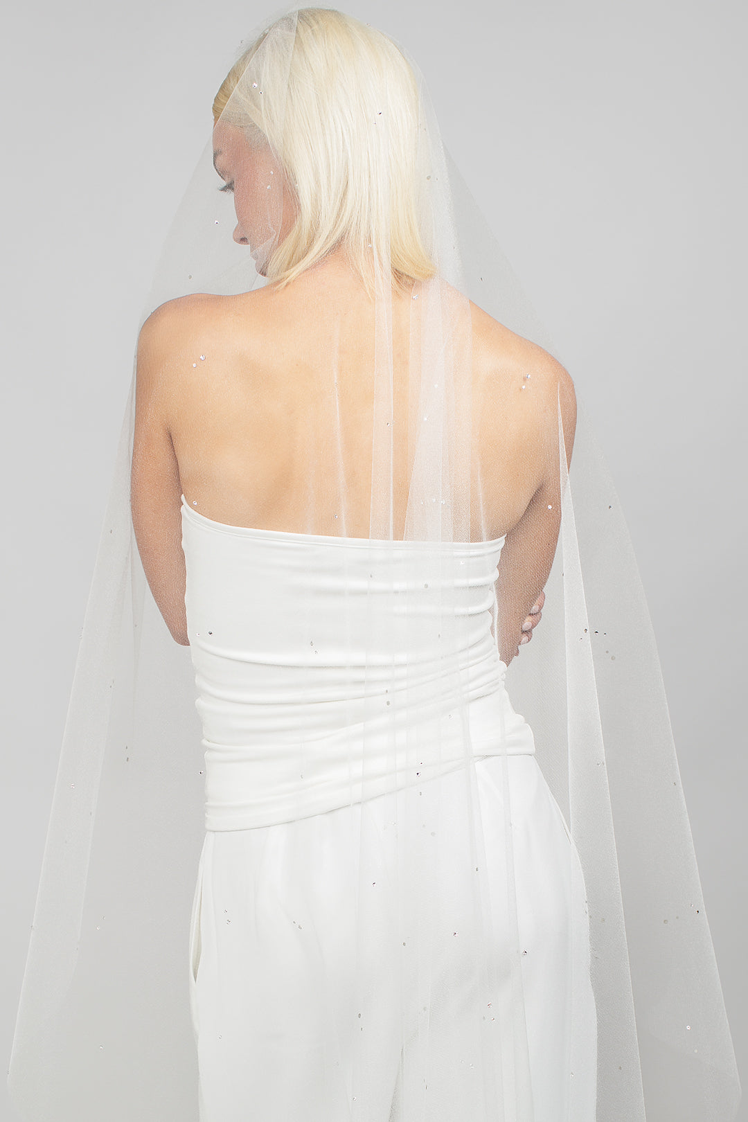 Waltz-length mantilla-cut bridal veil perfect for a simple veil to add to your wedding day look that is adorned with small scattered Austrian crystals, available in blush, lilac, and champagne hues.