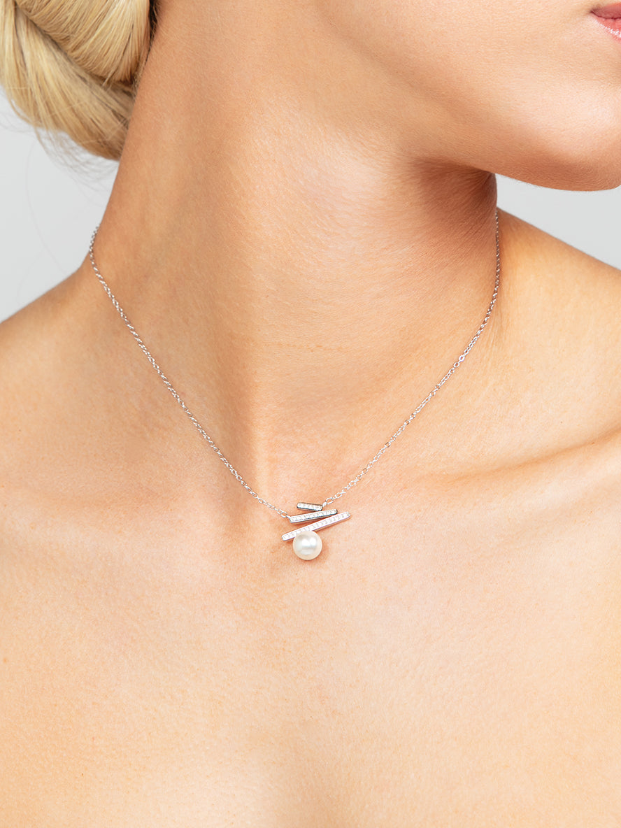 Dainty and elegant sterling silver triple bar pave cubic zirconia crystal pendant necklace with an 8mm pearl at the bottom.