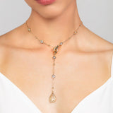 Gold Reed detachable choker and lariat necklace featuring an elegant, crystal chain and design with teardrop crystal drop shown worn in the front.