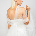 The modern tulle regal wrap shown in the back paired with the large silver Austrian pearl hoop earrings.