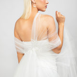 The modern tulle regal wrap shown in the back paired with the large silver Austrian pearl hoop earrings.