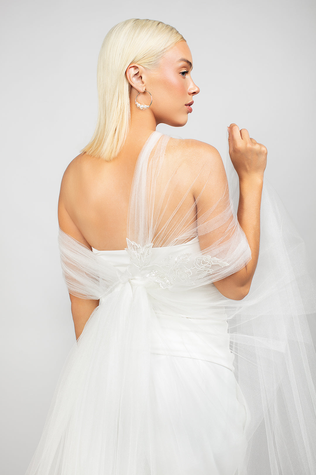 The modern tulle regal wrap shown in the back paired with the large silver Austrian pearl hoop earrings.