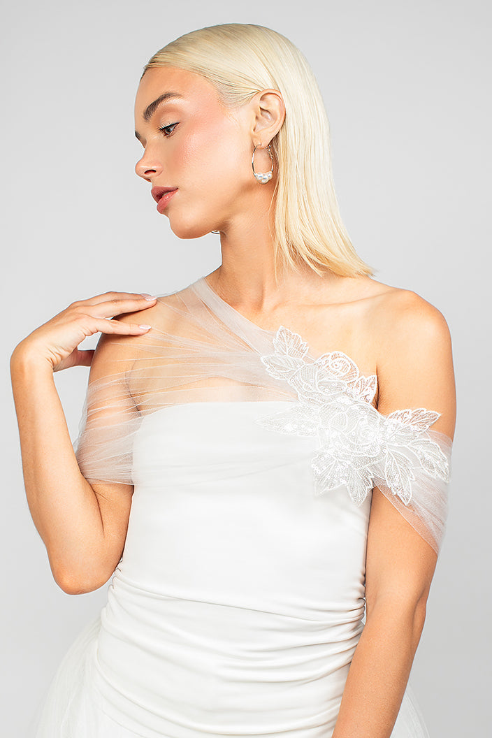 Front detail view of the elegant nylon sparkly tulle wrap with an asymmetrical design and sparkly sequin rose lace applique, adding elegance and modern drama to wedding looks.