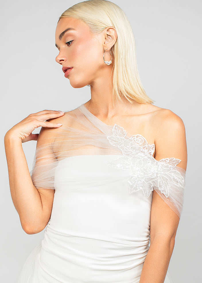 Front detail view of the elegant nylon sparkly tulle wrap with an asymmetrical design and sparkly sequin rose lace applique, adding elegance and modern drama to wedding looks.