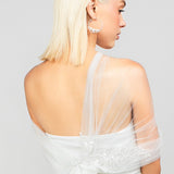 Back detail shot of the Regal modern tulle wrap with an asymmetrical design and sparkly sequin rose lace applique, adding drama to wedding day looks.