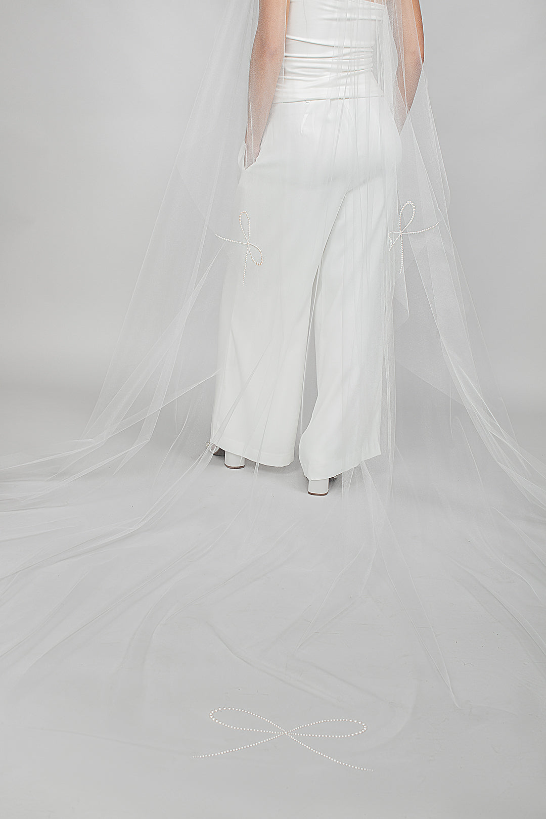 Cathedral length wedding veil showing the detailing of the Austrian pearl bows on the train and sides of the bridal veil