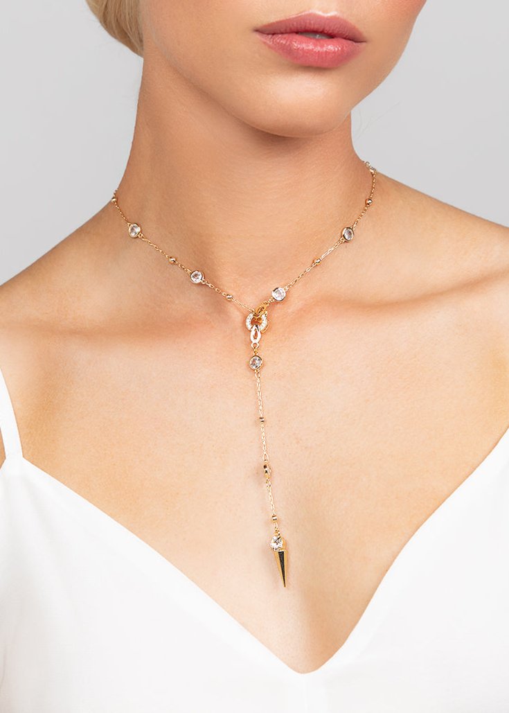 Edgy Ricky crystal spike lariat necklace, perfect for adding a modern edge sparkle to any outfit. Shown in trendy gold.