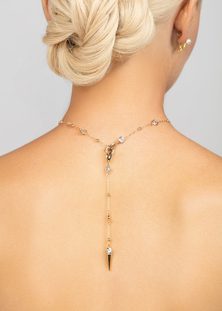 Ricky Spike necklace in gold with an edge detachable lariat geometric spike crystal pendant, worn in the back, for a modern and trendy look.