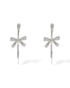 Product shot showing the glamorous pave crystal elongated post earrings with a crystal pave rope and pearl bow drop, designed for festive occasions.