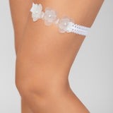 Elastic bridal garter featuring three sparkly vinyl flowers with Austrian pearl centers for a delicate and comfortable fit. One size fits most.