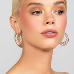 Gold-plated large hoops with floating Austrian pearls, designed for modern and versatile wear.