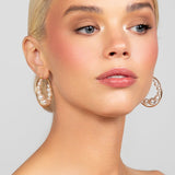 Gold-plated large hoops with floating Austrian pearls, designed for modern and versatile wear.