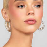 Large hoops with floating Austrian pearls, designed for modern and versatile wear shown in silver.