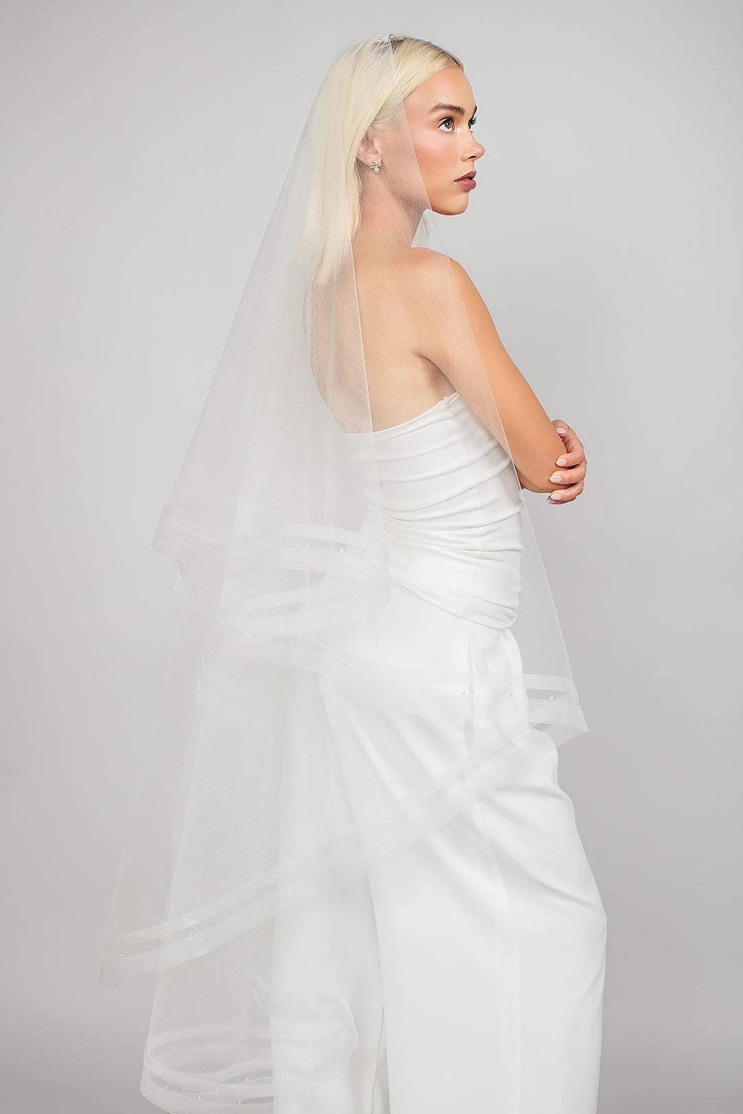 Side view of the 2 tier waltz-length fold over veil with a double row of horsehair trim and scattered Austrian crystals, available in bright white and sparkly light ivory 