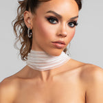 Model wearing the Savannah striped tulle scarf draped around her neck, the front view. Paired with the Sparkle large crystal hoop earrings.