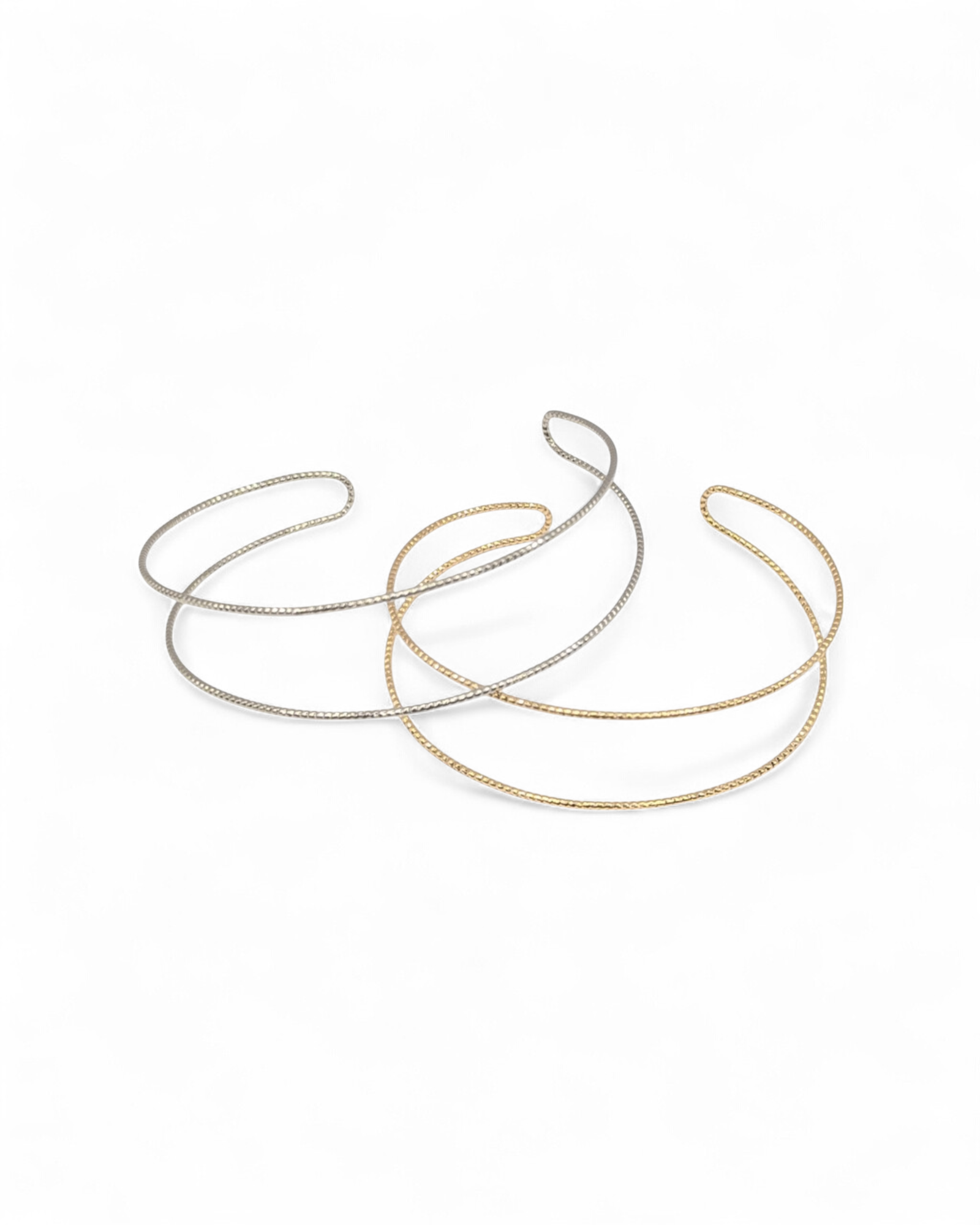 Spencer cuff bracelets in gold and silver side by side