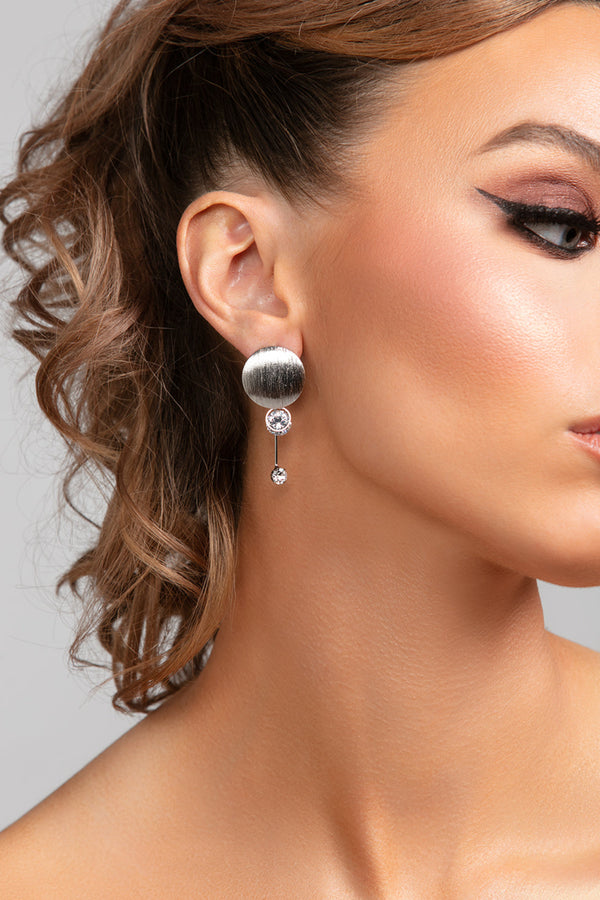 Model wearing Stacey earrings in silver with dimensional CZ crystal drop