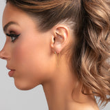 Model wearing Stevie earrings in gold with ball post and double chain drop