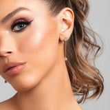 Model wearing Sylvia earrings in gold with CZ crystal drops