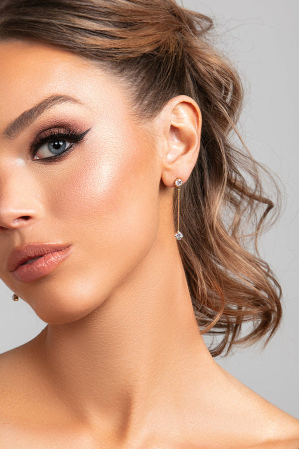 Model wearing Sylvia earrings in gold with CZ crystal drops