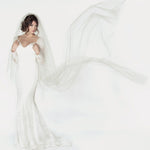Two tier cathedral length wedding veil with a handkerchief cut, and a clean raw cut edge. Showing the veil flying in the air.