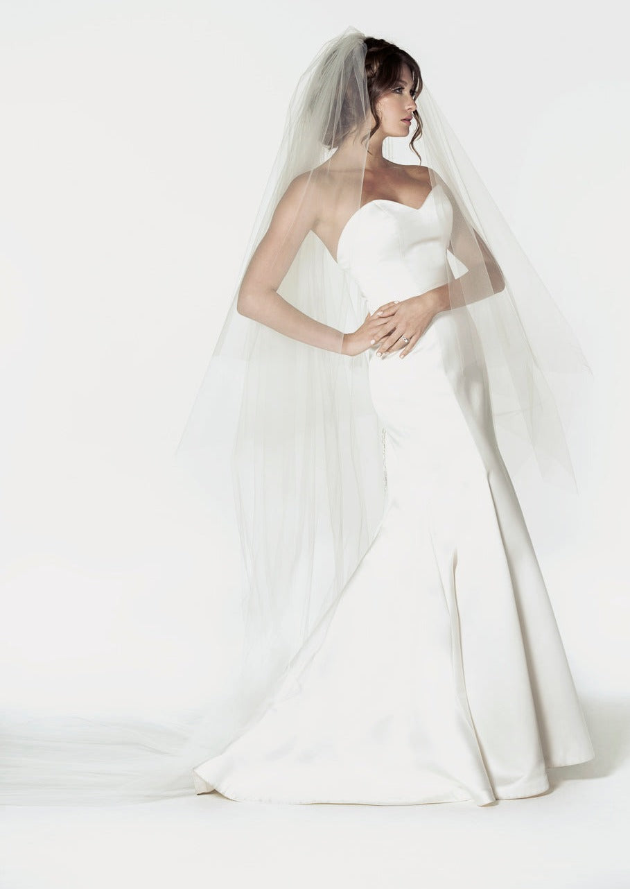 Two tier cathedral length wedding veil with a handkerchief cut, and a clean raw cut edge.