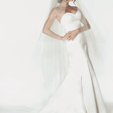 Two tier cathedral length wedding veil with a handkerchief cut, and a clean raw cut edge.